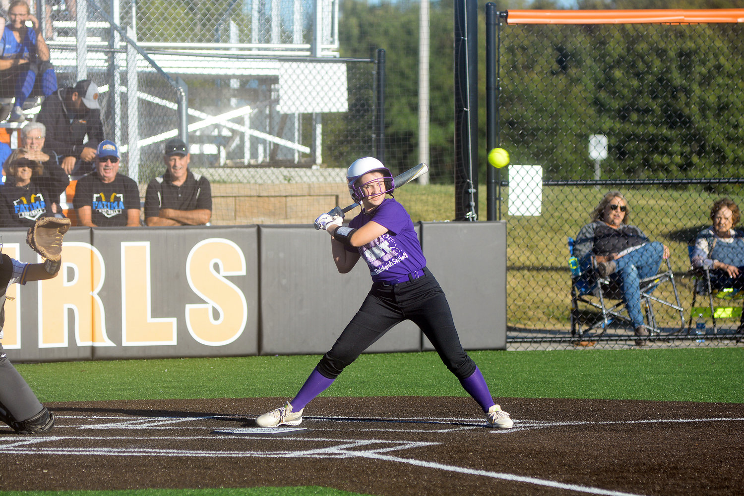 Grace Abell watches a high pitch go for ball for Owensville’s Dutchgirls in their annual purple out game last Monday night against Fatima’s Lady Comets. Abell was diagnosed with Hodgkin’s Lymphoma but has since rang the bell declaring her free from the cancer.